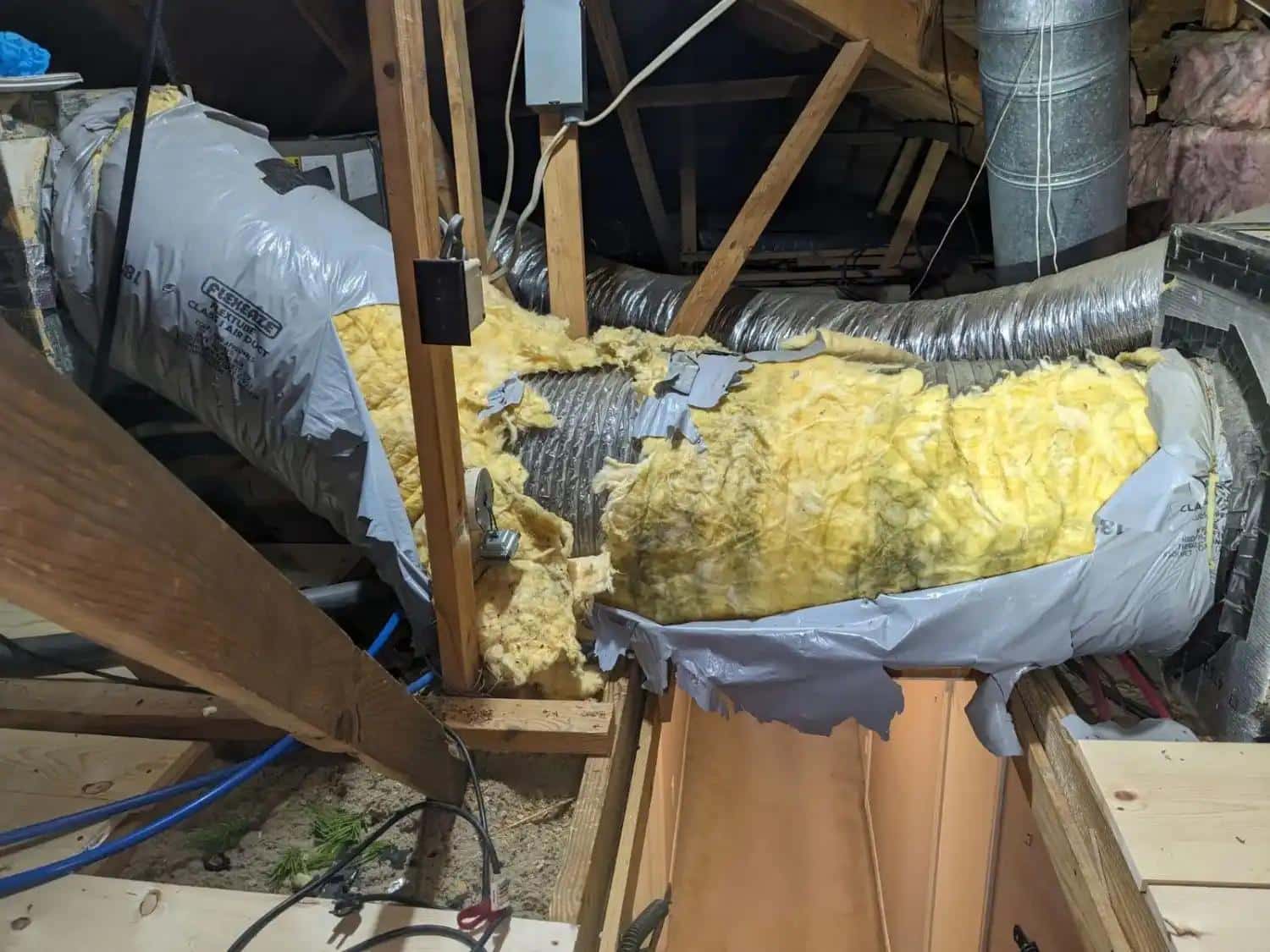 Disconnected HVAC duct allowing conditioned air to escape into the attic